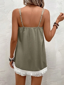 Detail of army green camisole with elastic back and white bohemian fringe lace trim