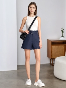 Detail view of high waisted scalloped shorts with metallic buckle and paperbag waist