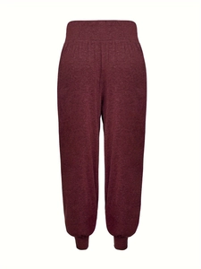 Detail of high-waist ribbed cuffs and marl texture on burgundy yoga pants