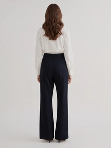 Elegant high-waisted wide leg trousers and white shirt set shown from the back view