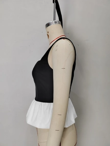 Top peplum chic nero e bianco con orlo a balze senza maniche e design a contrasto