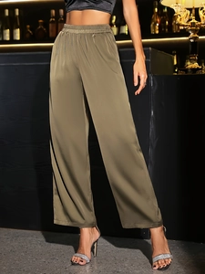 Detail of elegant olive green satin wide leg pants with elastic high waist and silky shine