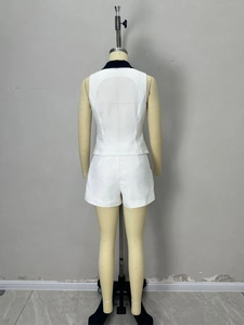 Women's white two-piece set with black contrast trim vest and shorts back view