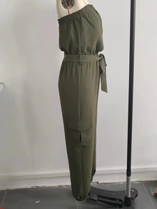 Detail of army green one-shoulder jumpsuit with cargo pockets and belted elastic waist