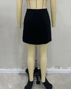 Detail view of the invisible back zipper on a chic black high-waist A-line mini skirt
