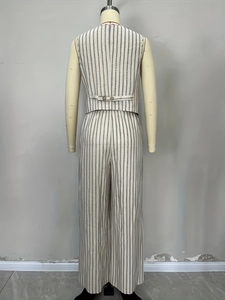 Detail view of the adjustable button back strap on a striped linen vest and trousers set
