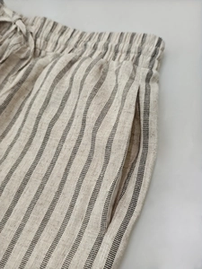 Detailed macro view of striped linen wide leg pants with drawstring elastic waist and side pockets