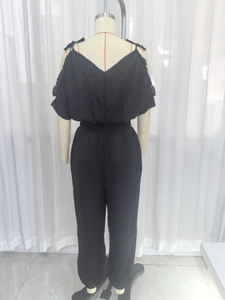 Women's black woven jumpsuit featuring a V-neck back design and an elastic waist detail
