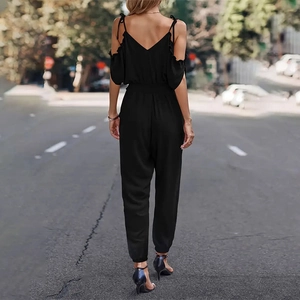 Rear view of black off-the-shoulder jumpsuit with ruffled sleeves and smocked waist