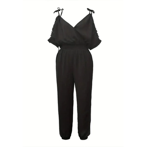 Detail of black woven jumpsuit showing thin straps with delicate shoulder bows