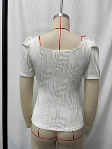 White ribbed short sleeve top with a square back and puff shoulder detail on a mannequin