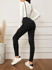 Women's knit jumpsuit with vertical stripes and white long sleeve turtleneck top