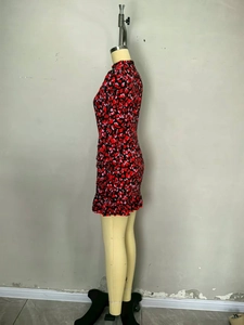 Detail of elegant red heart print mini dress showing ruffled hem and slim fit design
