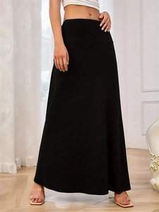 Close-up of high-waist A-line black knitted maxi skirt with elegant draping fabric