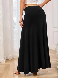 Rear view of long black knit maxi skirt showing the elegant silhouette and slim high waistline