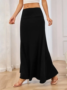 Detail view of high waisted black knit maxi skirt with mermaid hem and slim fit cut