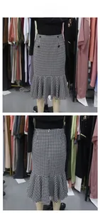 Close-up of houndstooth fishtail skirt featuring front buttons and ruffled hemline