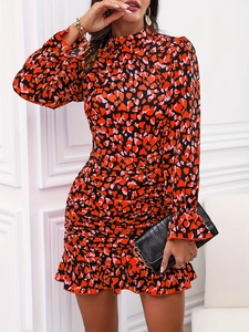 Close-up of elegant floral heart print dress featuring shirred details and ruffle cuffs