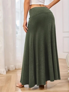 Detail of dark green heathered knit maxi skirt with elegant flowy drape and elastic waist