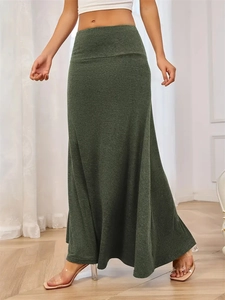Detail view of high-waisted olive green knit maxi skirt with elegant draping effect