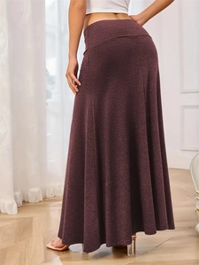 Rear view of a burgundy knitted mermaid maxi skirt showing the elegant high-waisted fit