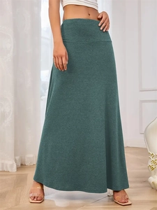 Detailed close-up of dark green knitted maxi skirt with soft texture and high waist design