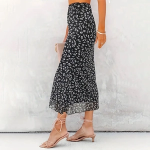 Detail of floral mesh skirt showing white flowers on black chiffon with ruffle hem