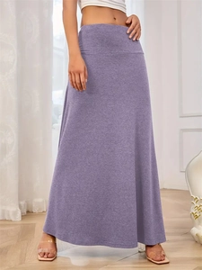 Close-up of a purple high-waisted knit maxi skirt showing soft drapes and fine texture