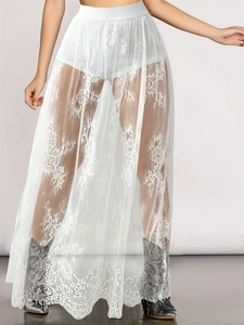 Close-up of white gothic lace maxi skirt with intricate floral mesh and high elastic waistband