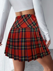 Preppy red plaid pleated mini skirt paired with a white long-sleeve cropped top