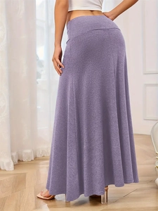 Detail of high waist heather purple knitted maxi skirt with soft drape on wooden floor