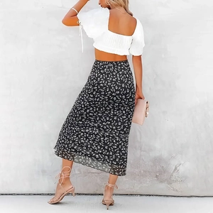 Detailed back view of high waisted floral midi skirt and white puff sleeve crop top