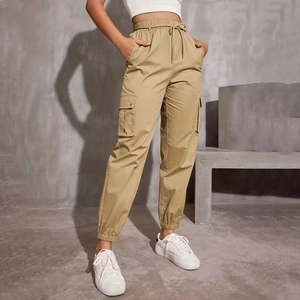 Detail of high-waist cargo pants showing drawstring waist and flap pockets in khaki