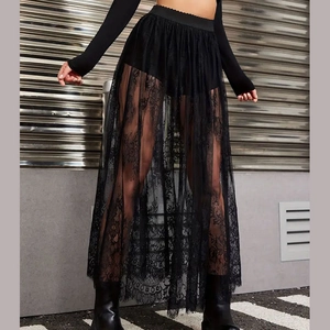 Detail of floral lace texture and sheer mesh hem on a black gothic high waist skirt