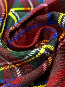 Detailed macro view of classic colorful tartan plaid fabric texture with twill weave