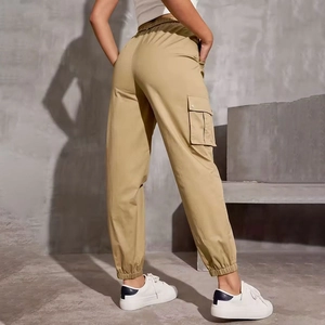 Detail view of khaki high-waisted cargo pants with side flap pockets and elastic cuffs