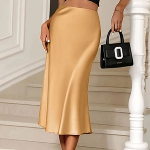 Detail view of champagne gold satin midi skirt showing luxurious fabric and drape effect