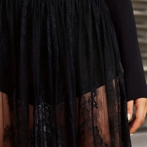 Detailed view of black gothic lace skirt featuring floral patterns and layered mesh texture