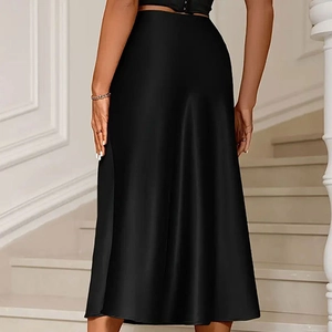 Rear view of sleek black satin A-line midi skirt with elegant draping on model