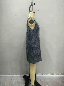 Close-up of blue and white tweed fabric texture on a sleeveless V-neck sheath dress