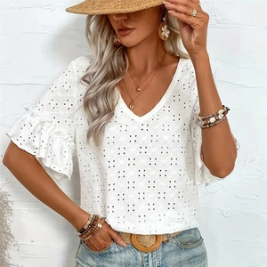 Close-up of white V-neck top with delicate eyelet lace embroidery and ruffle sleeves