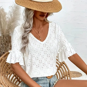 Detail of white V-neck lace top with embroidered eyelets and elegant ruffle sleeves