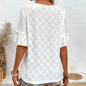 Detail of white eyelet embroidery and layered ruffle sleeves on the bohemian blouse