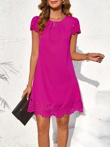 Close-up of fuchsia knit dress featuring delicate hollow embroidery on the hemline