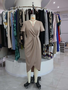 Detail view of khaki satin midi dress with wrap V-neck and twisted waist design