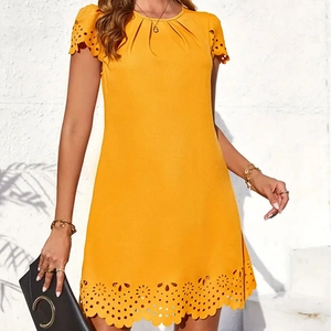 Detail of laser-cut scalloped eyelet hem and pleated round neck on yellow A-line dress