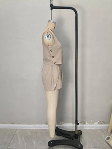 Detail shot of the khaki two-piece set featuring decorative side buttons and wrap shorts cut