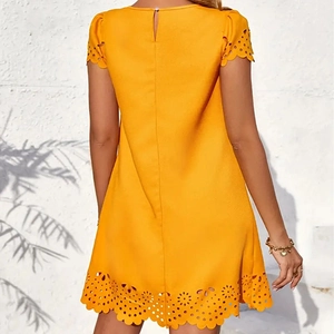 Detailed back view of a yellow A-line dress featuring burnout hollow patterns and button closure