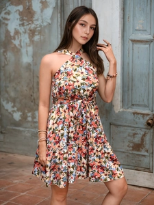 Close-up of bohemian floral print dress with halter neck and ruffled hem details