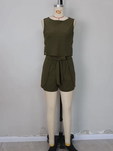 Detail of olive green two-piece set featuring side metal buttons and a bow-tie waist